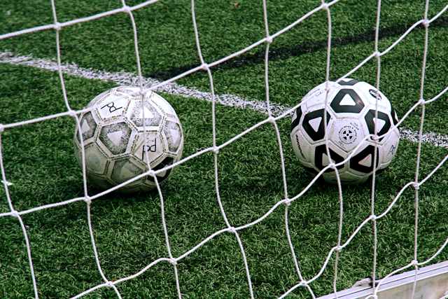 Soccer balls on a football pitch