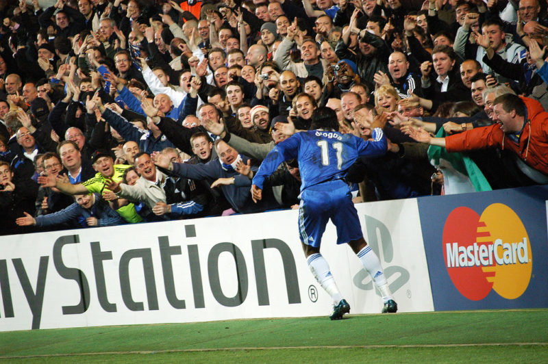 A player celebrating a goal with the fans
